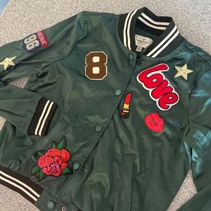 AE green “bomber” jacket with decals. Size M Teen